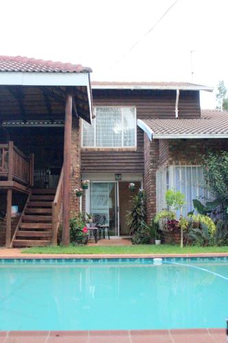 a house with a swimming pool in front of it at 513 on Mulberry in Pretoria