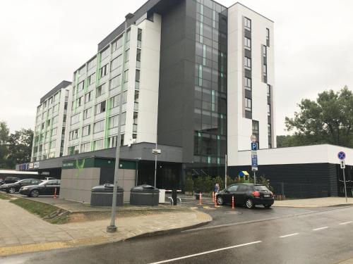 a building with a car parked in front of it at Antakalnis 5 stars apartment in Vilnius