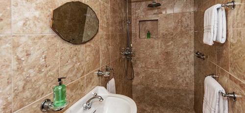 a bathroom with a sink and a mirror at Mill Of Nethermill Holidays in Pennan