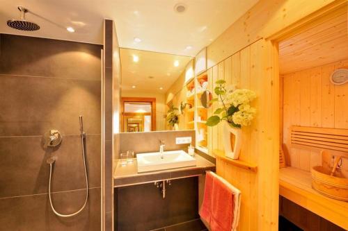 a bathroom with a sink and a shower at Ferienwohnungen Schmidbauer in Fischen