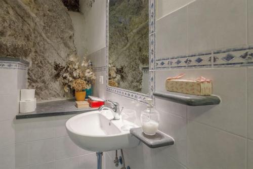 a white bathroom with a sink and a window at La Cantina di Lorenza in Vernazza