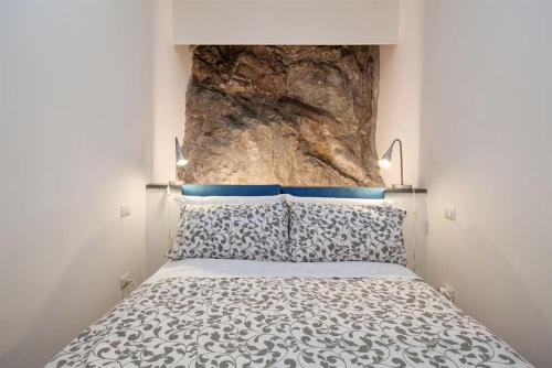 a bedroom with a bed with a large rock above it at La Cantina di Lorenza in Vernazza