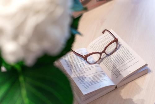 a pair of glasses sitting on top of a book at Hotel Maritimo in Makarska