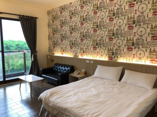 a bedroom with a bed and a chair and a wall at Taroko Inn in Xincheng