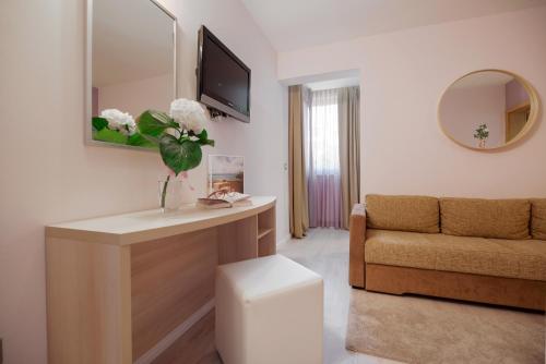 a living room with a table and a couch at Hotel Maritimo in Makarska