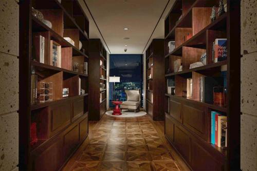 a library with wooden shelves and a chair in a room at Royal Hotel Seoul in Seoul