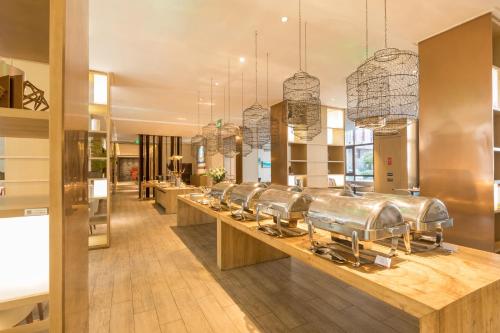 a kitchen with a row of copper pots on a counter at Xi'an Bell Tower Atour S Wu Hotel in Xi'an