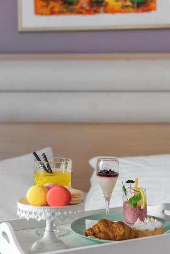 a table with a plate of food and a glass of wine at Hotel Maritimo in Makarska
