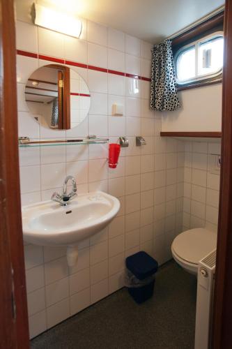 a bathroom with a sink and a toilet at Hotelboot Sarah in Amsterdam