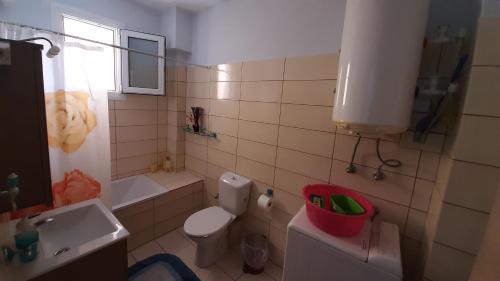 a bathroom with a white toilet and a sink at Apartment with Balcony and Parking in Kavála