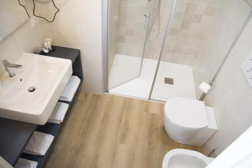 a bathroom with a sink and a toilet and a shower at Casa Beccherie in Lazise