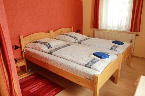ein Schlafzimmer mit einem Holzbett mit blauen Handtüchern darauf in der Unterkunft Ferienwohnung im Herzen des Nationalparks in Hohnstein