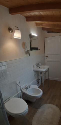 a bathroom with two toilets and a sink at Il mulino di Aurora in Dosso del Liro