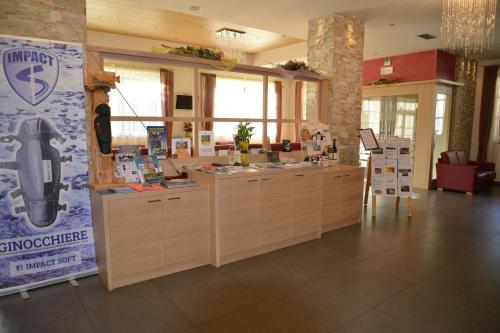 a store with a counter in a room at Hotel Bel Sit in Comano Terme