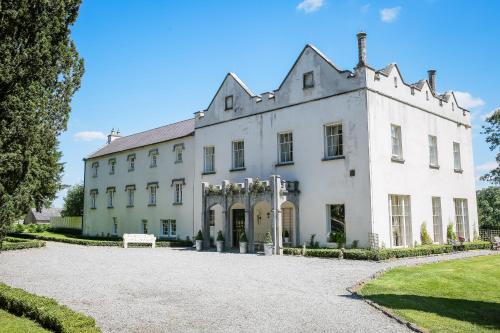 a large white house with a driveway at Annamult Country House Estate in Kilkenny