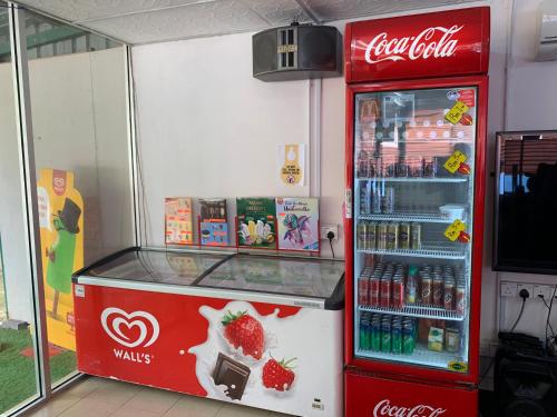 a cocacola soda machine in a store at Happy Paradise in Kampung Janda Baik
