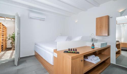 a bathroom with a sink and a bed in a room at Dreambox Mini Villas in Ornos