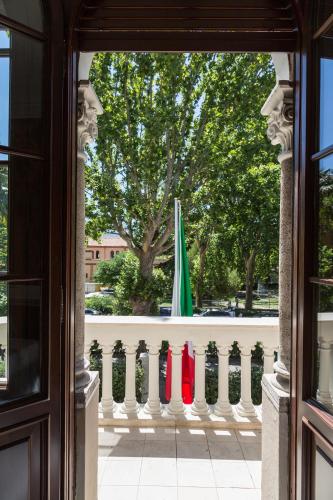 a view through a window of a fence with two umbrellas at Relais Metelli in Foligno