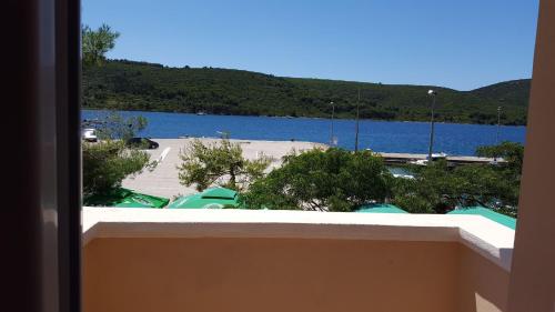 a view of a large body of water from a balcony at Pansion Kaleb in Brbinj