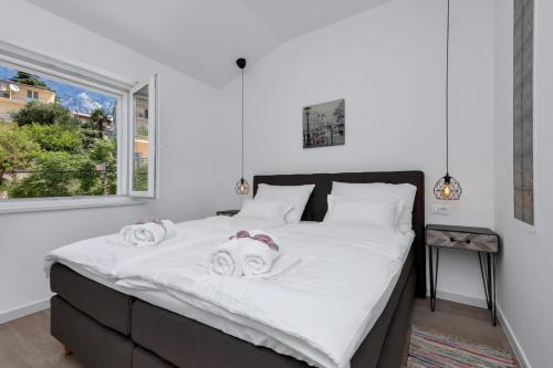 a bedroom with a large bed with towels on it at Apartment Teraca in Makarska