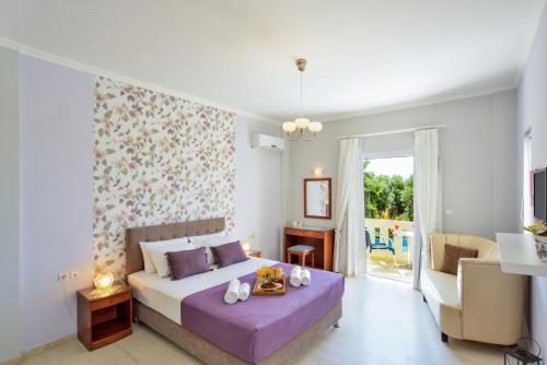 a bedroom with a bed and a living room at Poseidon Apartments in Kato Daratso