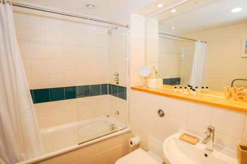 a bathroom with a shower and a toilet and a sink at Hamilton Court Apartments from Your Stay Bristol in Bristol