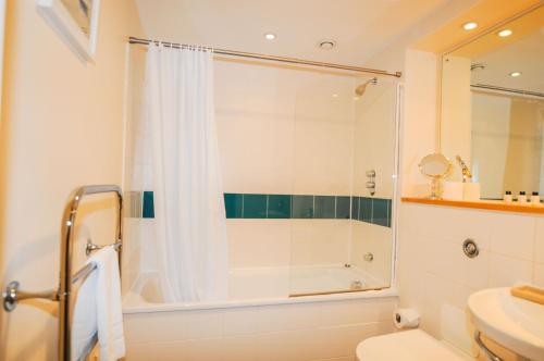 a bathroom with a shower and a toilet and a sink at Hamilton Court Apartments from Your Stay Bristol in Bristol