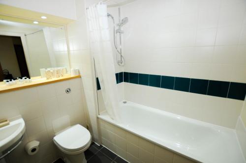 a bathroom with a toilet and a shower and a sink at Hamilton Court Apartments from Your Stay Bristol in Bristol