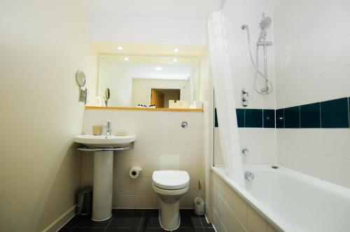 a bathroom with a toilet and a sink and a shower at Hamilton Court Apartments from Your Stay Bristol in Bristol
