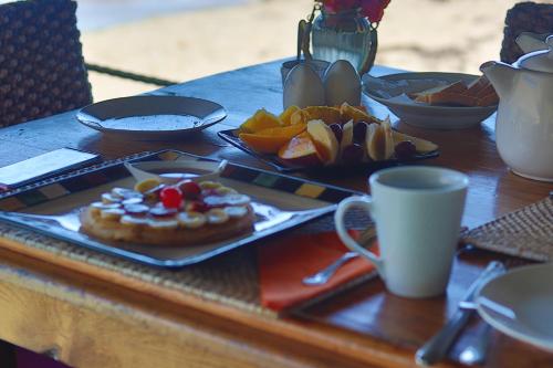 a table with a plate of food on a table at Tenuta Chatham Bay in Union Island