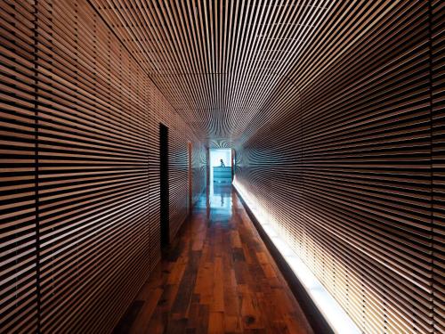 a hallway with a light at the end of a tunnel at The Standard Miami in Miami Beach
