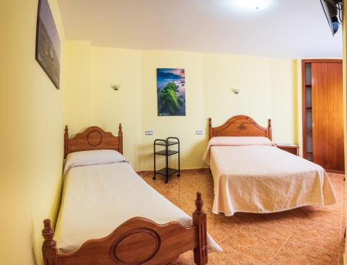 Posteľ alebo postele v izbe v ubytovaní Hostal O Camouco