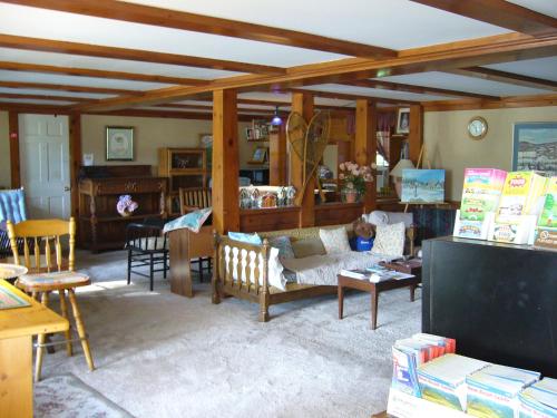 un soggiorno con divano, sedie e tavolo di White Trellis Motel a North Conway