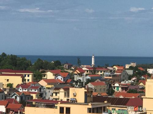 a city with a lighthouse in the distance at Windy Hotel Quang Binh in Dong Hoi