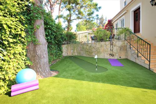 a putting green with a golf ball next to a tree at Casa Roma in Almancil