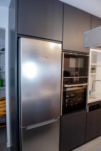 a stainless steel refrigerator in a kitchen at IN Lindos in Líndos