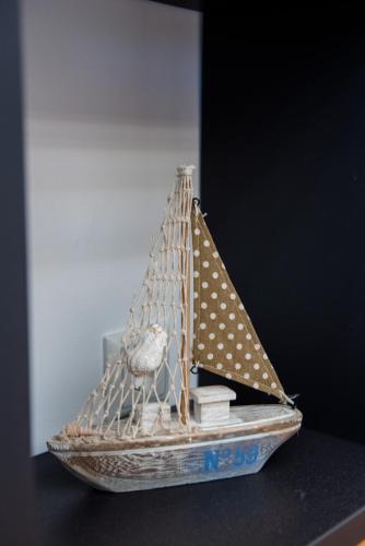 a small model of a boat on a table at IN Lindos in Líndos