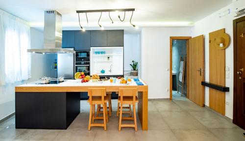 a kitchen with a large island with bar stools at IN Lindos in Líndos