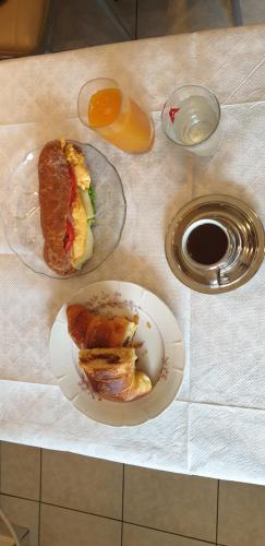 a table with a sandwich and a plate of food at Alexia's Apartments in Rio