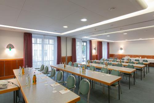a conference room with long tables and chairs at Residenz Hotel Detmold in Detmold