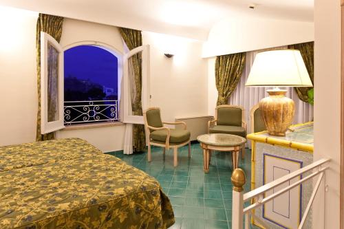 a hotel room with a bed and a window at Grand Hotel Il Moresco in Ischia