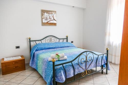 a bedroom with a bed with a blue comforter at Terra Mia in Agerola