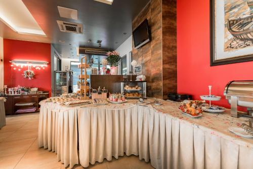 a restaurant with a table with food on it at Hotel Maritimo in Makarska