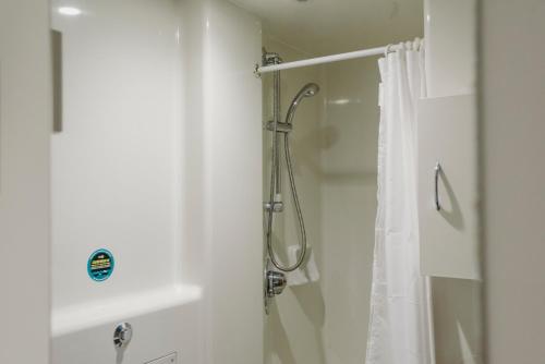 a bathroom with a shower with a shower curtain at Glasney Rooms, University Campus Penryn in Falmouth