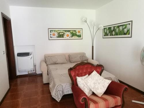 a living room with a couch and a chair at Alberta in Bertiolo