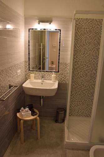 a bathroom with a sink and a shower at Le camere della Nonna in Diano Marina