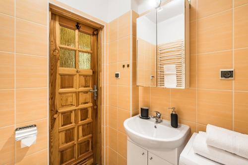 a bathroom with a sink and a mirror at Sea Flats - Studio in Sopot