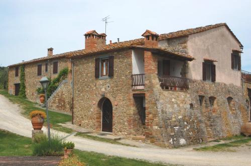 an old stone building with a balcony on it at Due Piani in Barberino di Val dʼElsa
