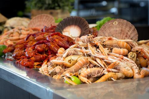 a pile of lobsters and other seafood on a display at DFDS Ferry - Copenhagen to Oslo in Copenhagen