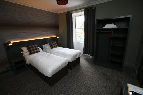 a bedroom with two beds and a window at Kings Arms Hotel in Melrose